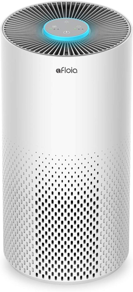 Afloia Kilo White Air Purifier featuring a sleek, modern design with a cylindrical body and top air outlet, displayed in a spacious bedroom for effective air purification in large rooms.
