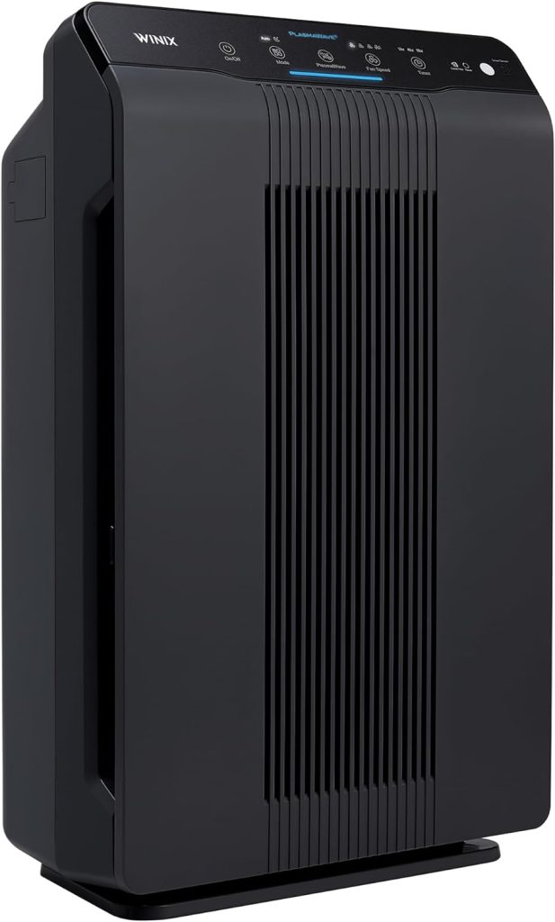 Winix 5500-2 Air Purifier featuring a modern black design, digital display, and control panel, equipped with True HEPA filtration, placed in a stylish living room setting. 